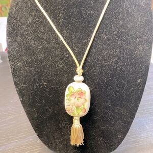 Avon hand painted floral pendant on cream colored cord